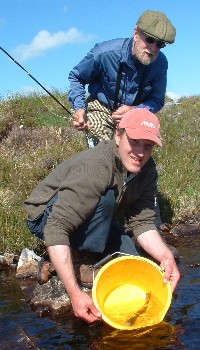 Dugie Foreman returns a wildtrout to a hill loch above Loch Maree Dugie Foreman returns a wildtrout to a hill loch above Loch Maree